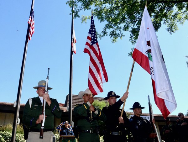 A multi-agency Honor Guard stands at attention at Kings County Government Center.